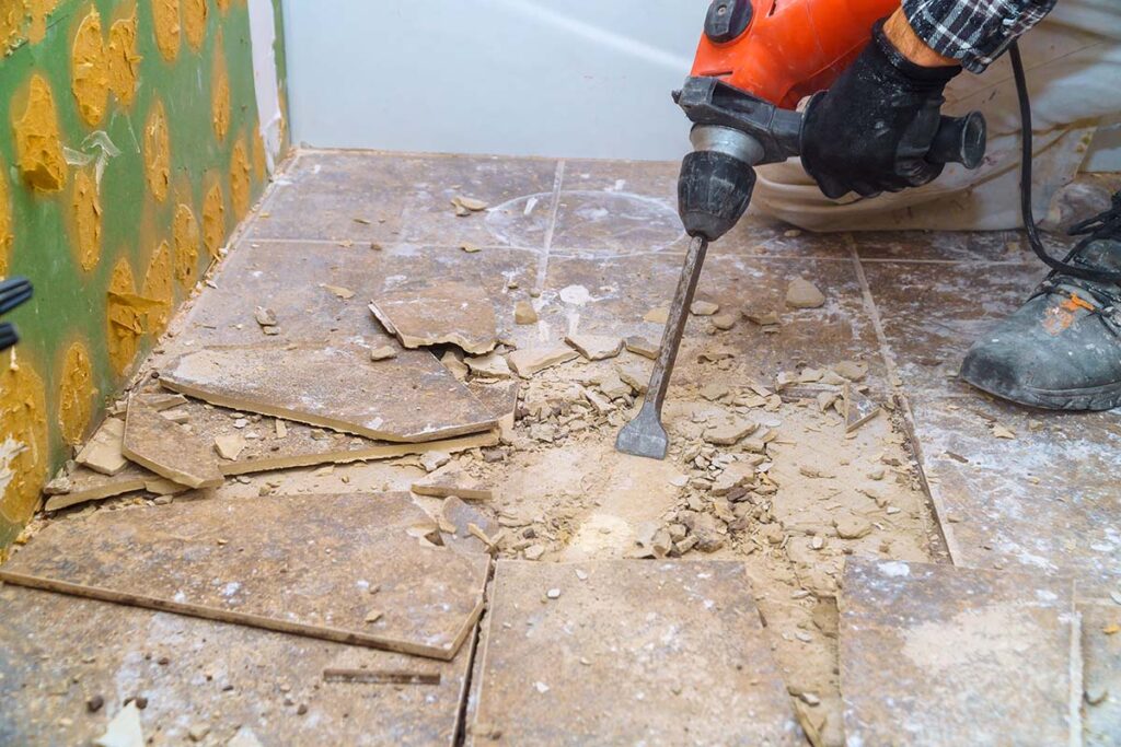 Worker Remove, Demolish Old Tiles A Bathroom With Jackhammer